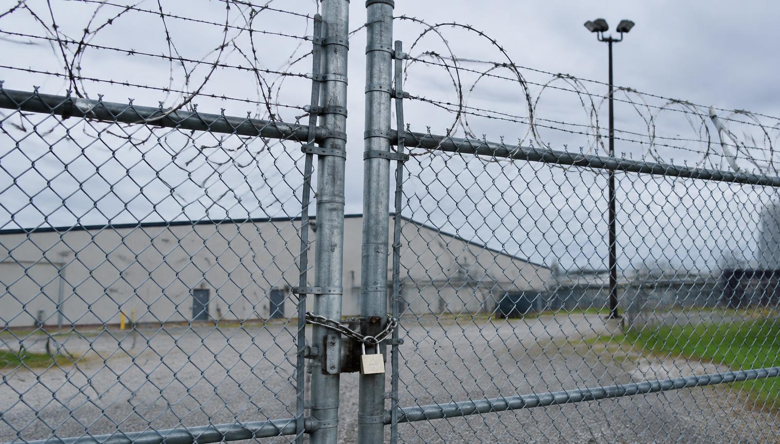 Representative image of secured chain-link perimeter fencing and gate at a federal facility